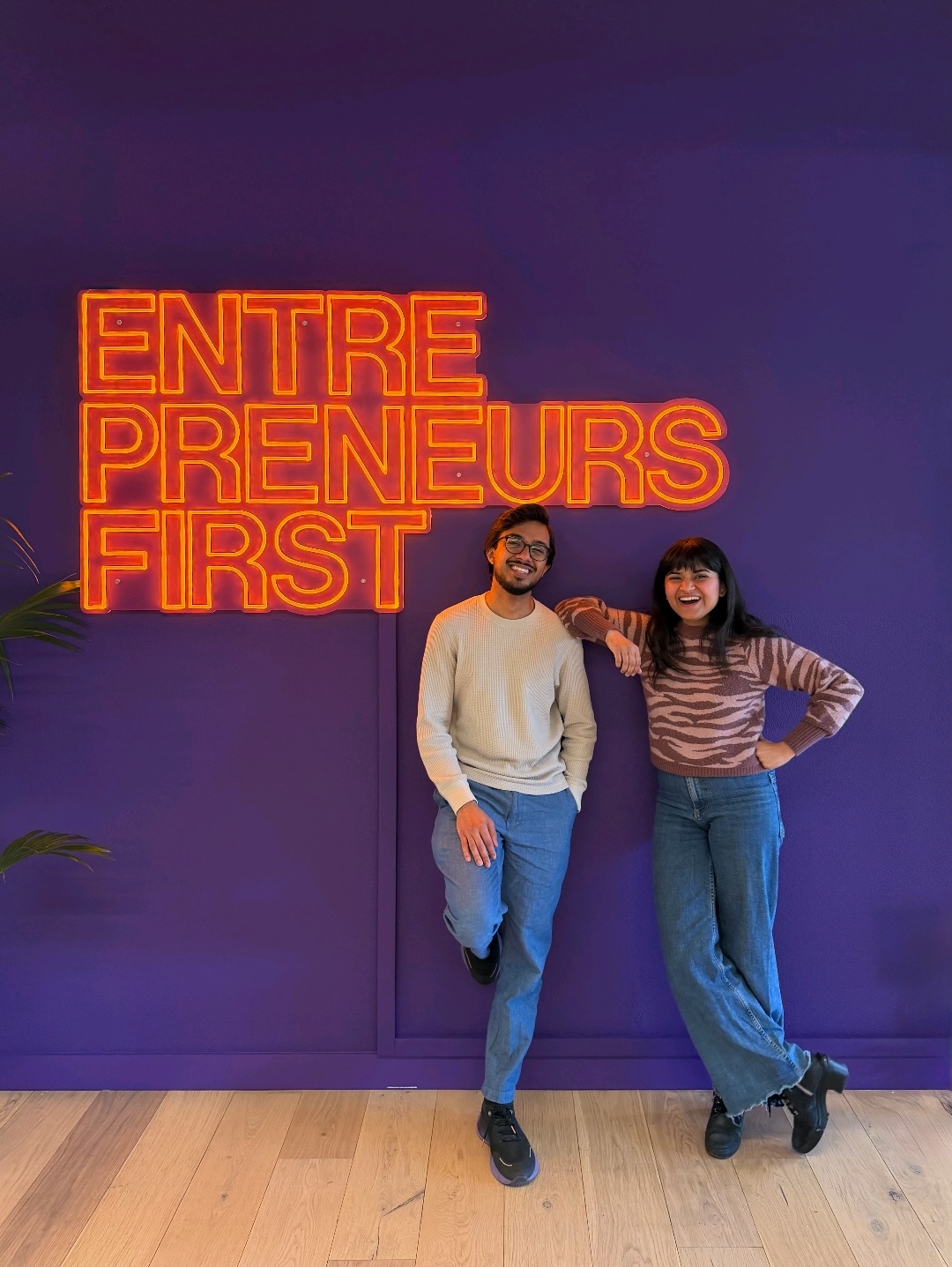 Tanmay Gupta and Vidhi Desai standing together in front of an Entrepreneurs First sign.